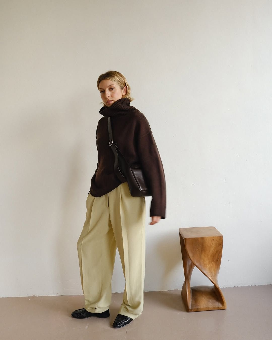 @brittanybathgate wears yellow trousers, brown jumper and loafers