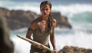 Alicia Vikander Tomb Raider wielding a spear on the beach