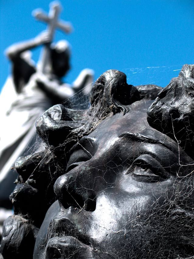 religious statues showing a cross and the face of an angel.