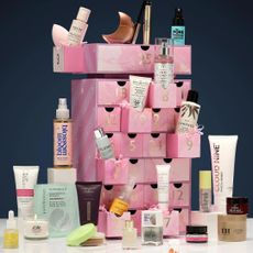 Image shows selection of beauty products spilling out of the Next affordable beauty advent calendar for 2024