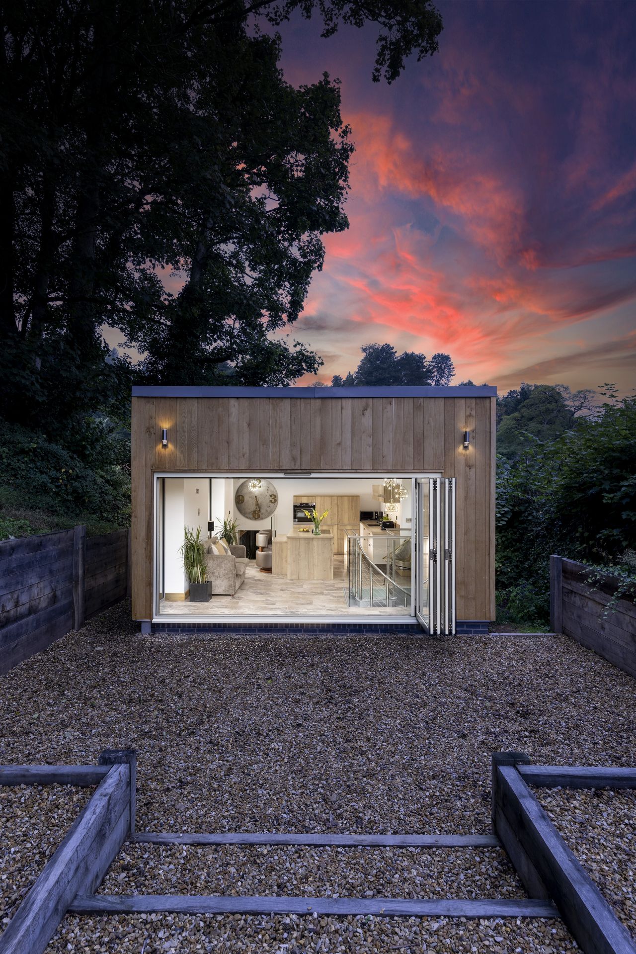timber clad house with open bifold doors
