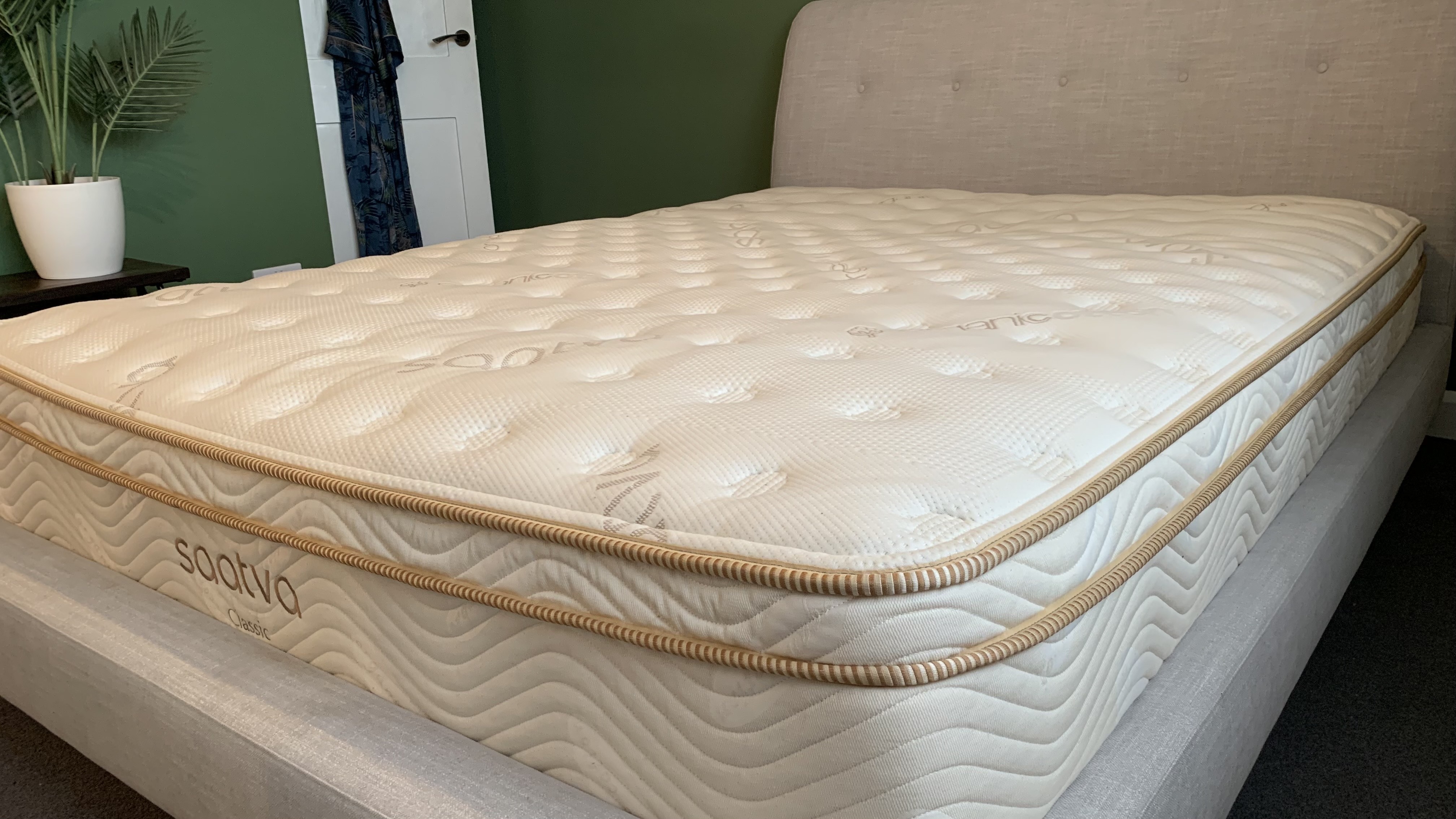 My review sample of the queen size Luxury Firm 11.5" Saatva Classic mattress photographed on a grey fabric bedframe in my main bedroom at home, which is where I do all of my queen size mattress testing