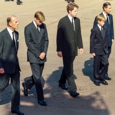 Prince Philip, Prince William, Earl Charles Spencer, Prince Harry, and King Charles walk together behind the carriage carrying the casket of Princess Diana on its way to the funeral