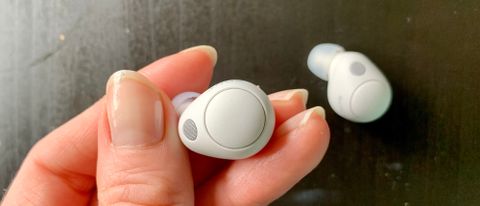 Sony WF-C700N earbuds held in a hand