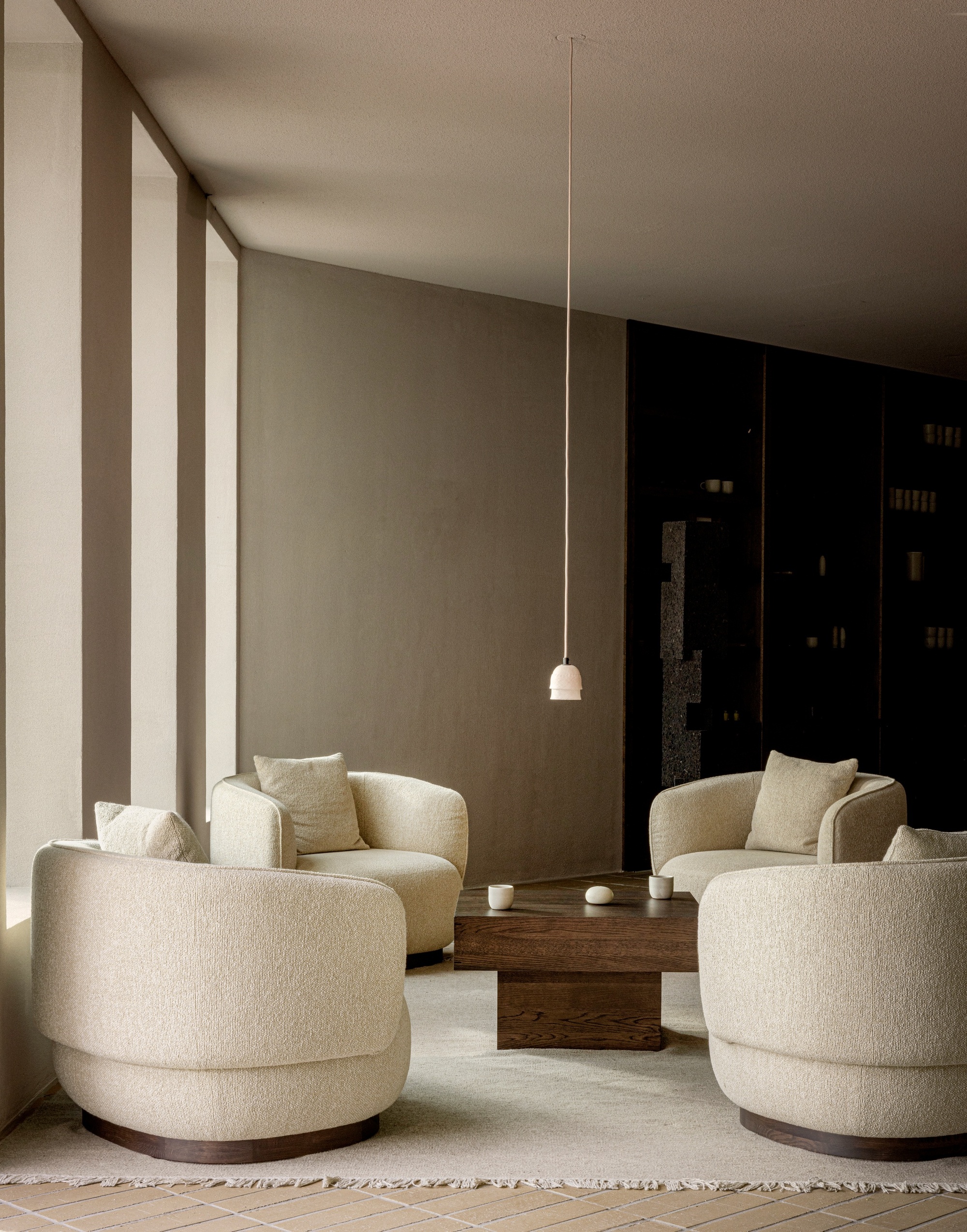 A Scandi living room with four white swivel armchairs around a wooden coffee table