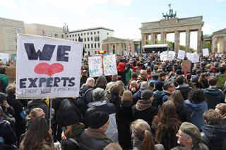 People gather in front of the Brandenburg Gate in support of scientific research during the March for Science in Berlin, Germany.