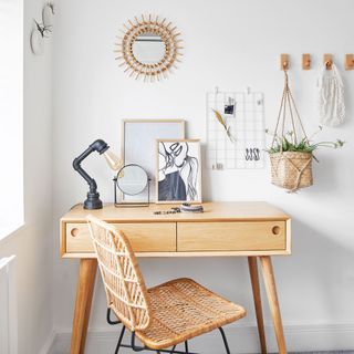 white home office with light wood furniture and decorative accessories