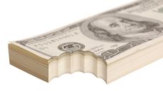 A stack of hundred-dollar bills with a bite out of the corner.