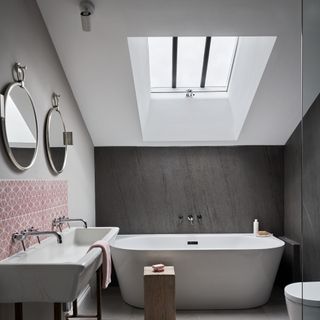 A modern bathroom with a bathtub and a sky light