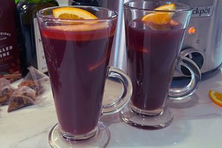 Two glasses of mulled wine on a kitchen counter