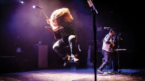 Claudio from Coheed and Cambria jumping on stage