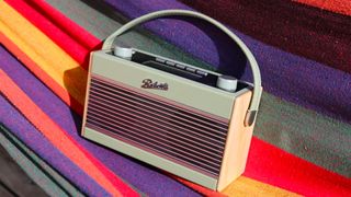 the roberts rambler bt stereo dab radio against a multicoloured backdrop