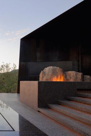 modern patio with angular scultpure and raised firepit