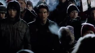 Tom Cruise stands in a crowd looking stunned in War Of The Worlds