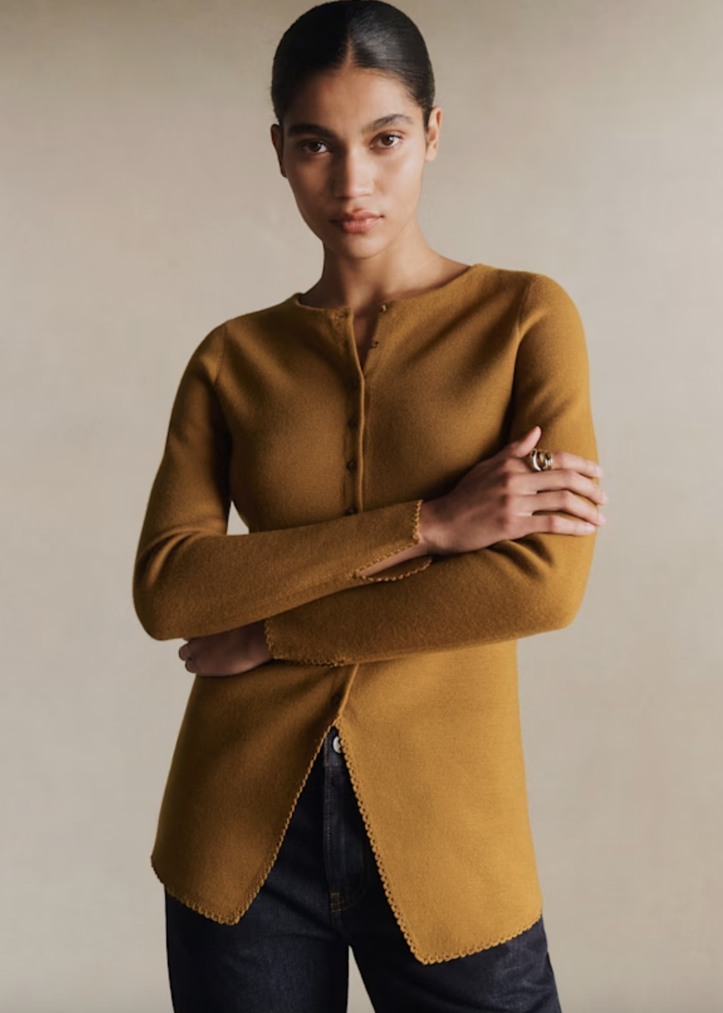 a model wearing an ochre sweater