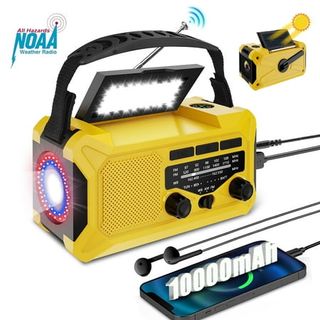 A yellow wind-up radio with a torch and light at the top, phone charger cable coming out of the back, and a charging phone next to it. 