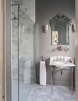 Grey bathroom with antique mirror and simple lighting