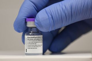 A vial of the Pfizer-BioNTech vaccine at a vaccination site in Cardiff, United Kingdom.