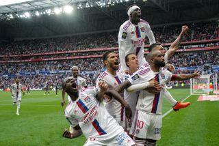 Alexandre Lacazette and his Lyon team-mates celebrate their thrilling comeback win over Montpellier in Ligue 1 in May 2023.