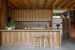 A kitchen island featuring wooden panelling