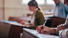 College students take a test in a classroom.