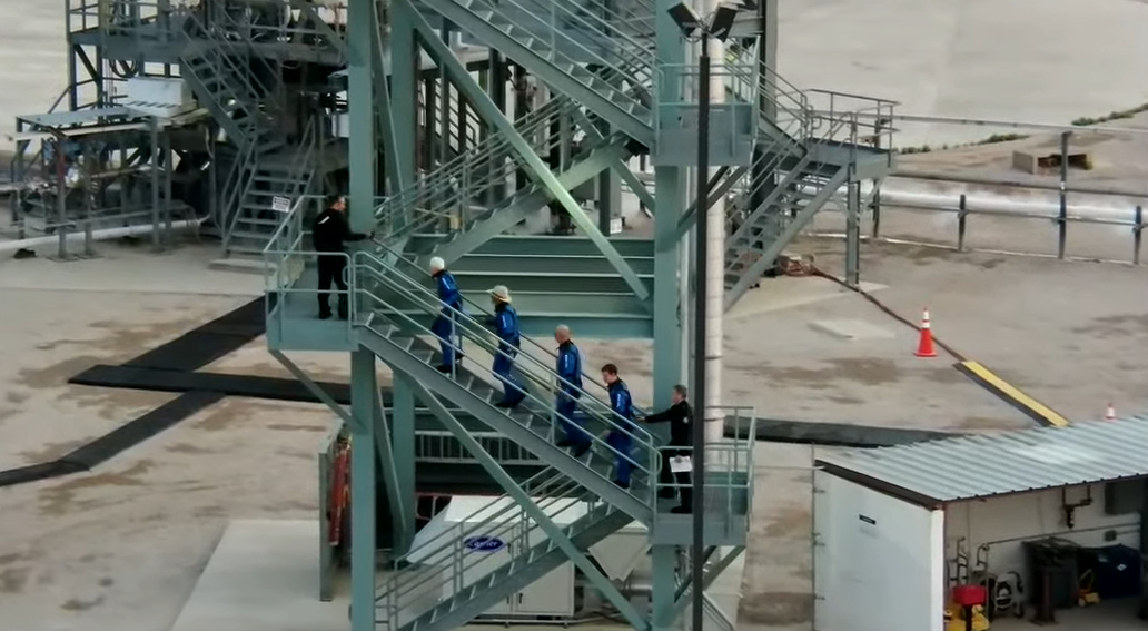 Wally Funk, Jeff Bezos, Mark Bezos and Oliver Daemen climb the steps to the New Shepard capsule before launch on July 20, 2021.