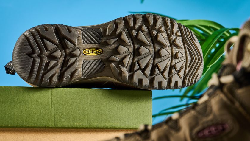 Keen Targhee IV hiking boots photographed in front of a blue background. 