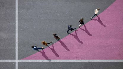 people walking on pavement painted pink