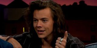 Harry Styles with long hair appearing on talk show