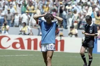 Michel Platini reacts after being shown a yellow card during France's quarter-final against Brazil at the 1986 World Cup.