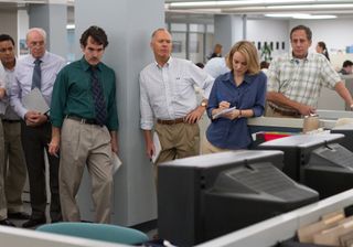 Michael Keaton, Rachel McAdams and others stand in the newsroom of the Boston Globe