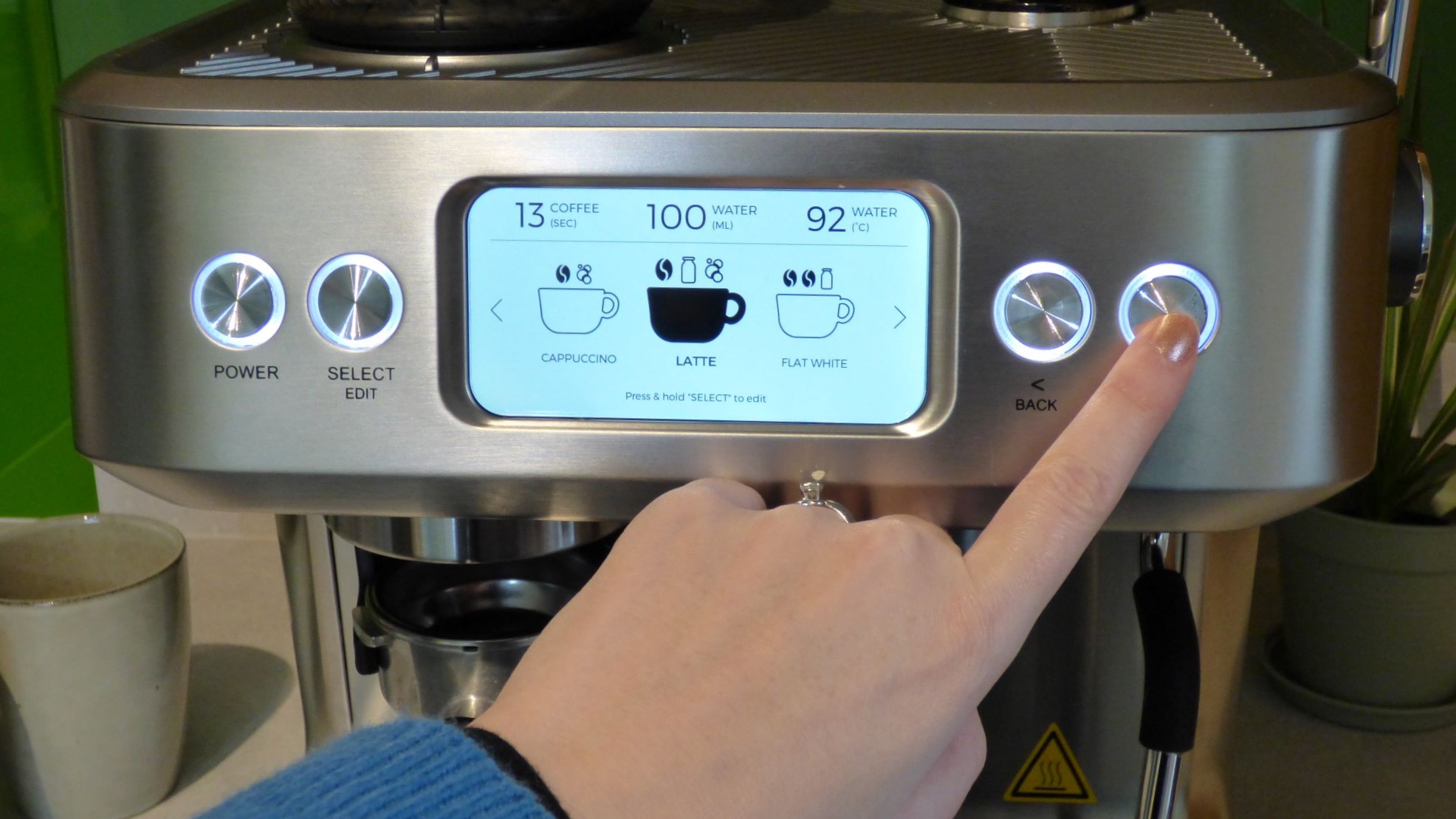 Person selecting drink using ProCook Bean To Cup Espresso Coffee Machine