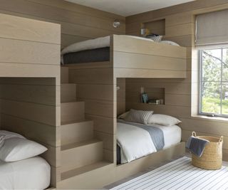 built in pale wood cabin bunk beds with steps