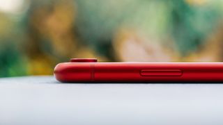 The side of an iPhone XR in red