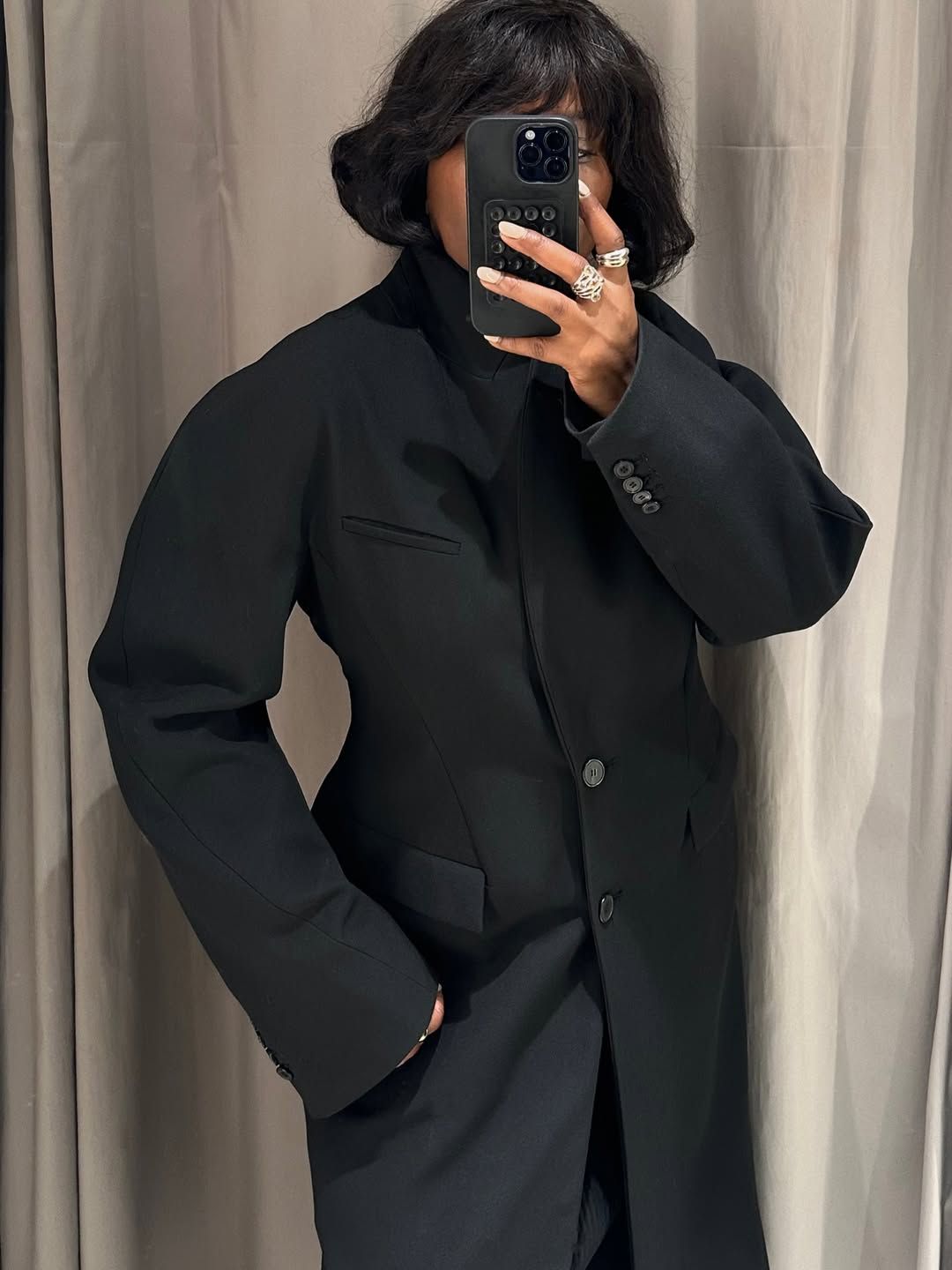 Franny in a waisted coat and statement rings