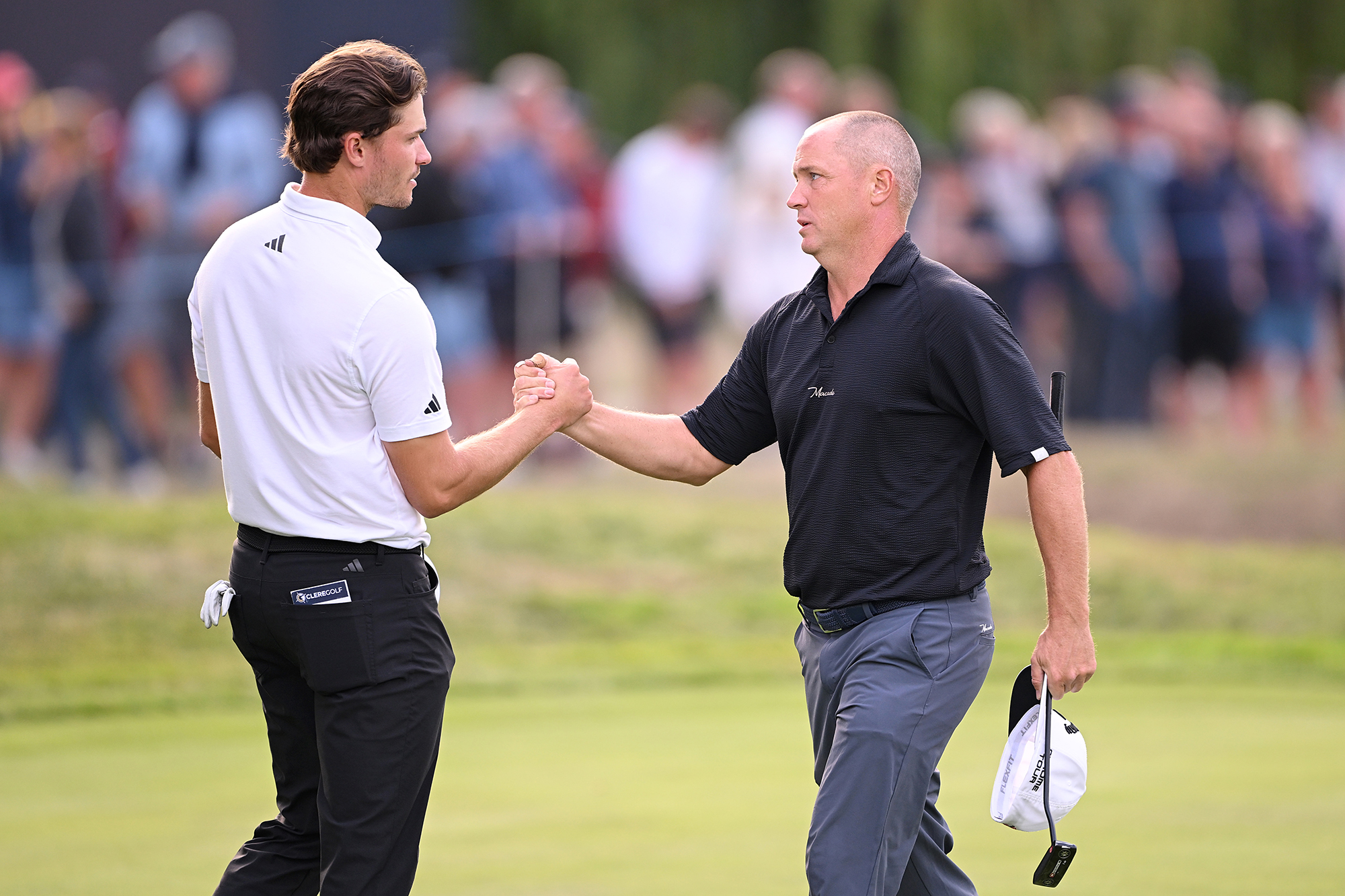 Alex Noren and Rasmus Hojgaard shaking hands at the Betfred British Masters 2025