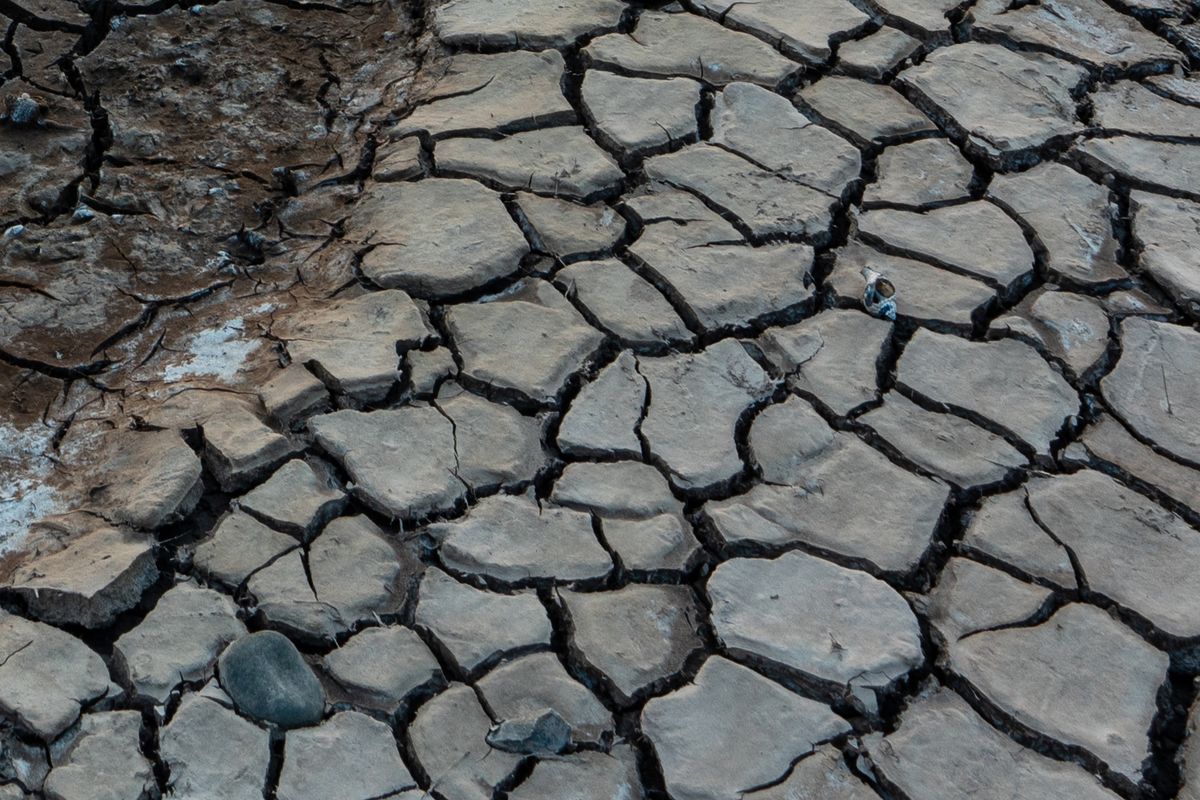 A sunset over some cracked flatlands