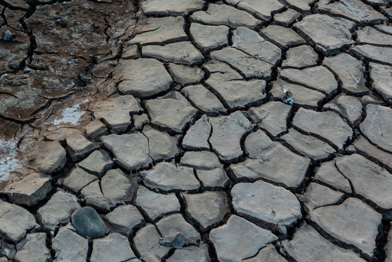 A sunset over some cracked flatlands