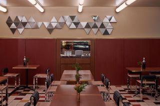 dining area with triangular tiles decorating wall, by dimorestudio