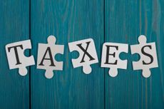 the word taxes written on puzzle pieces