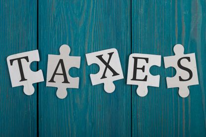 the word taxes written on puzzle pieces