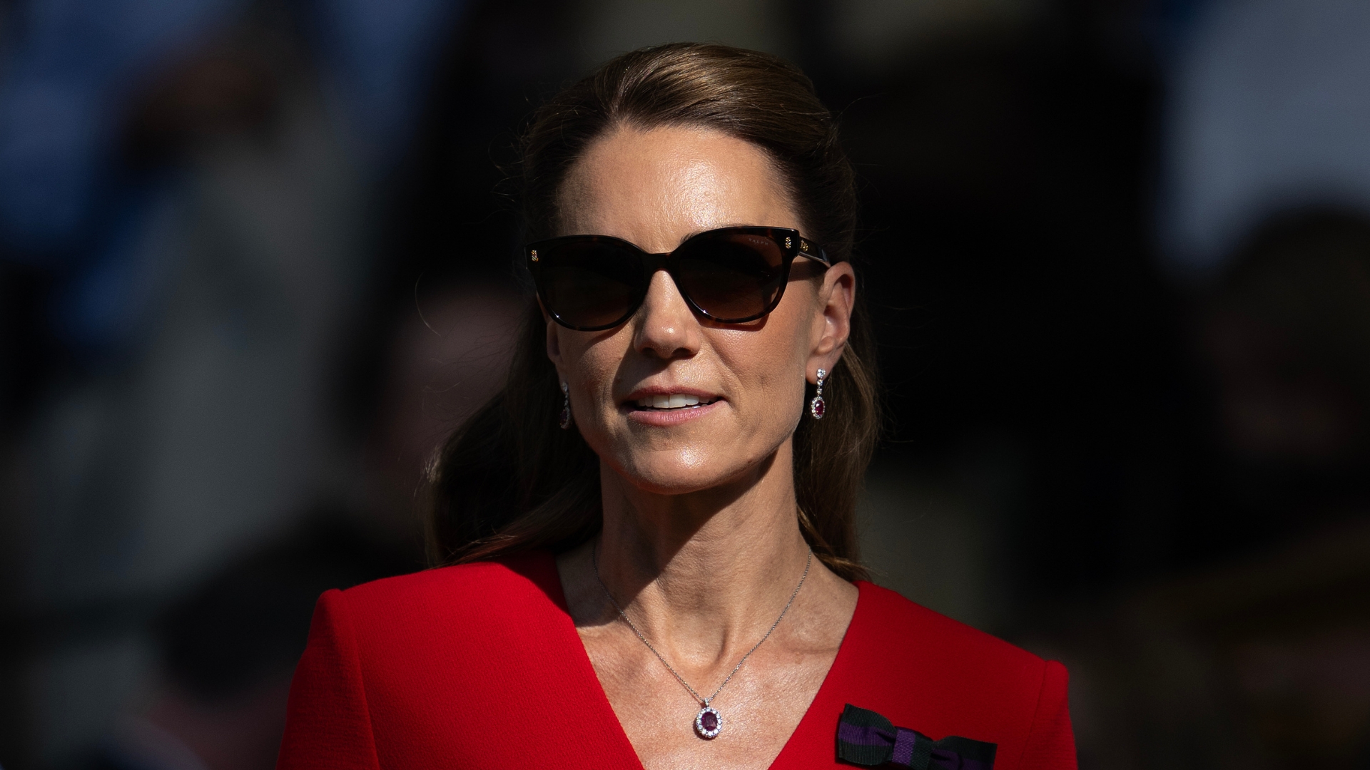 Catherine, Princess of Wales, is pictured wearing a red dress, sunglasses and with her hair up in a half-up, half-down style, whilst in the centre court royal box during the Women's Singles final on day thirteen of The Championships Wimbledon 2026 at All England Lawn Tennis and Croquet Club on July 11, 2026, in London, England.