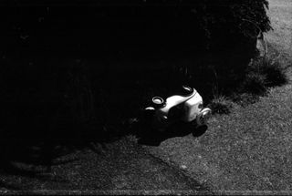 Child's toy car on its side in an moody black and white environment