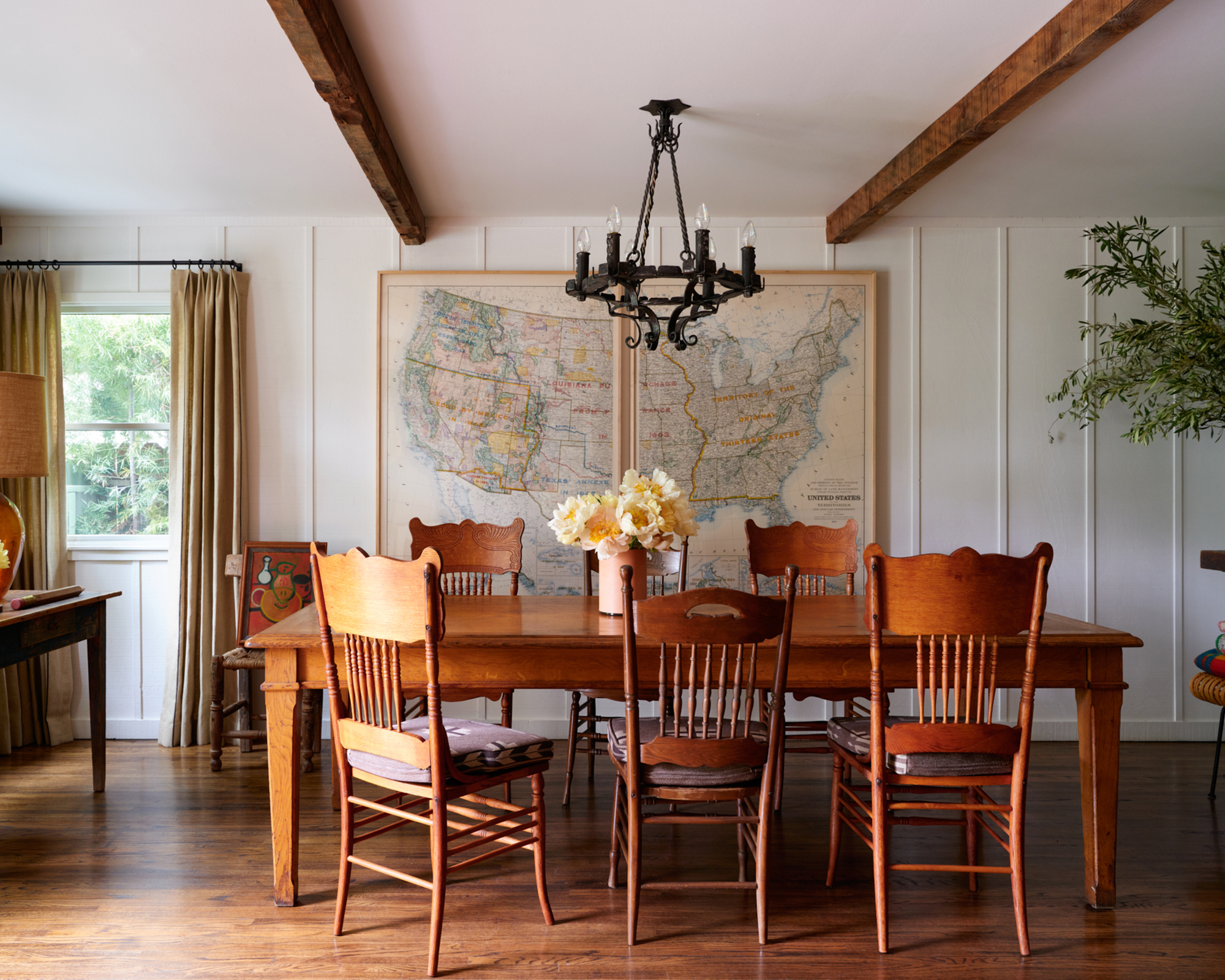dining room with wood table and antique chairs and cast iron chandelier