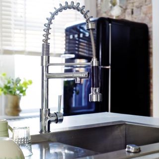 black fridge with mixer tap and glasses