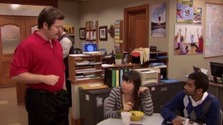 Nick Offerman as Ron Swanson, wearing his Tiger Woods outfit while talking to April and Tom