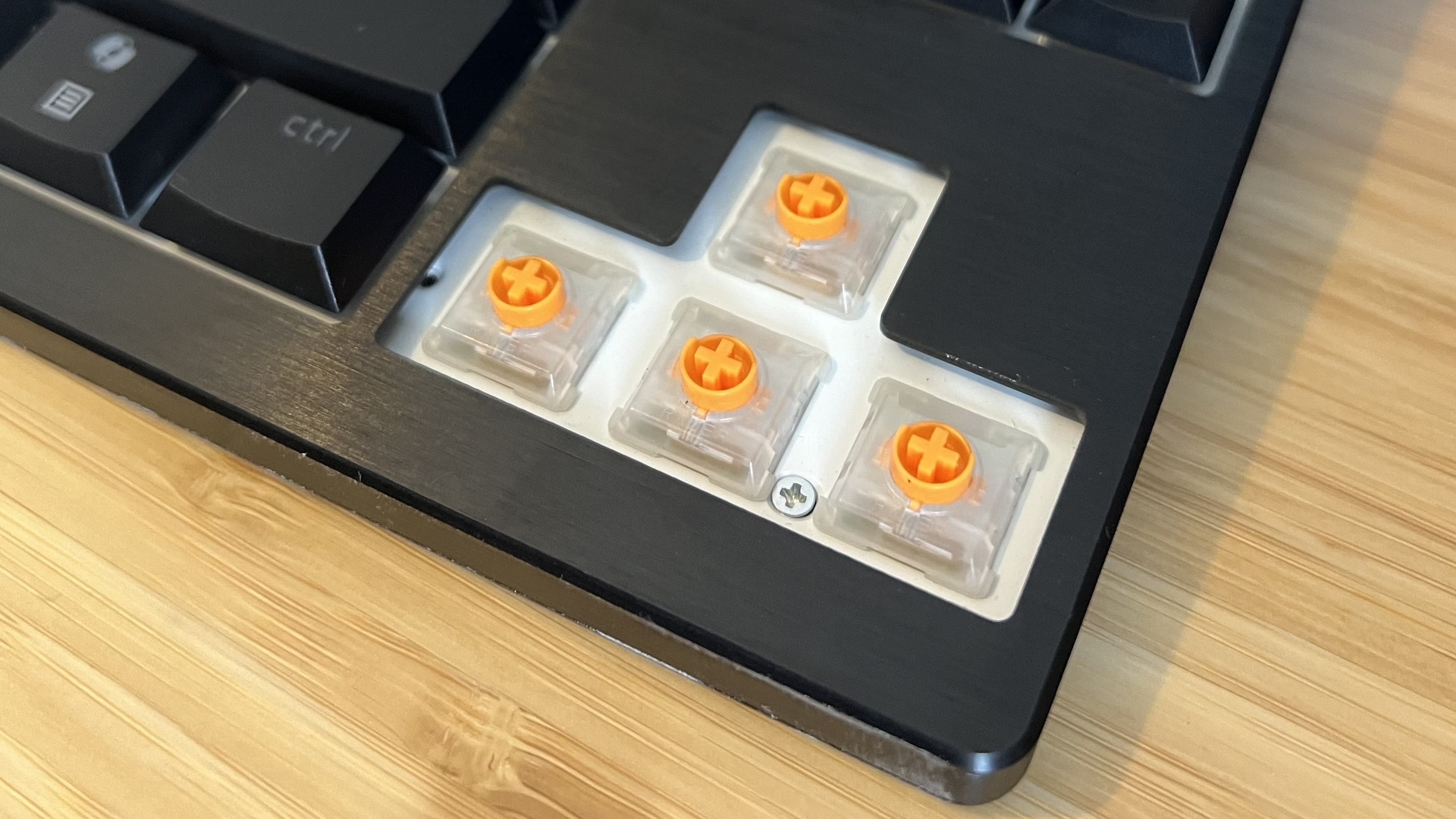 Close up on orange switches inside arrow keys on Razer Blackwidow V4 Low Profile gaming keyboard