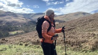Julia Clarke hiking in the Norrona falketind thermo60 Hood jacket