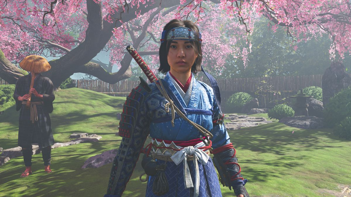 Assassin&#039;s Creed Shadows hideout best buildings and upgrades - Naoe standing in front of a cherry blossom tree in the hideout.