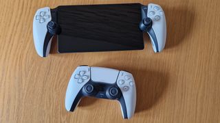 PlayStation Portal ligger på ett bord bredvid en vanlig DualSense-kontroller.